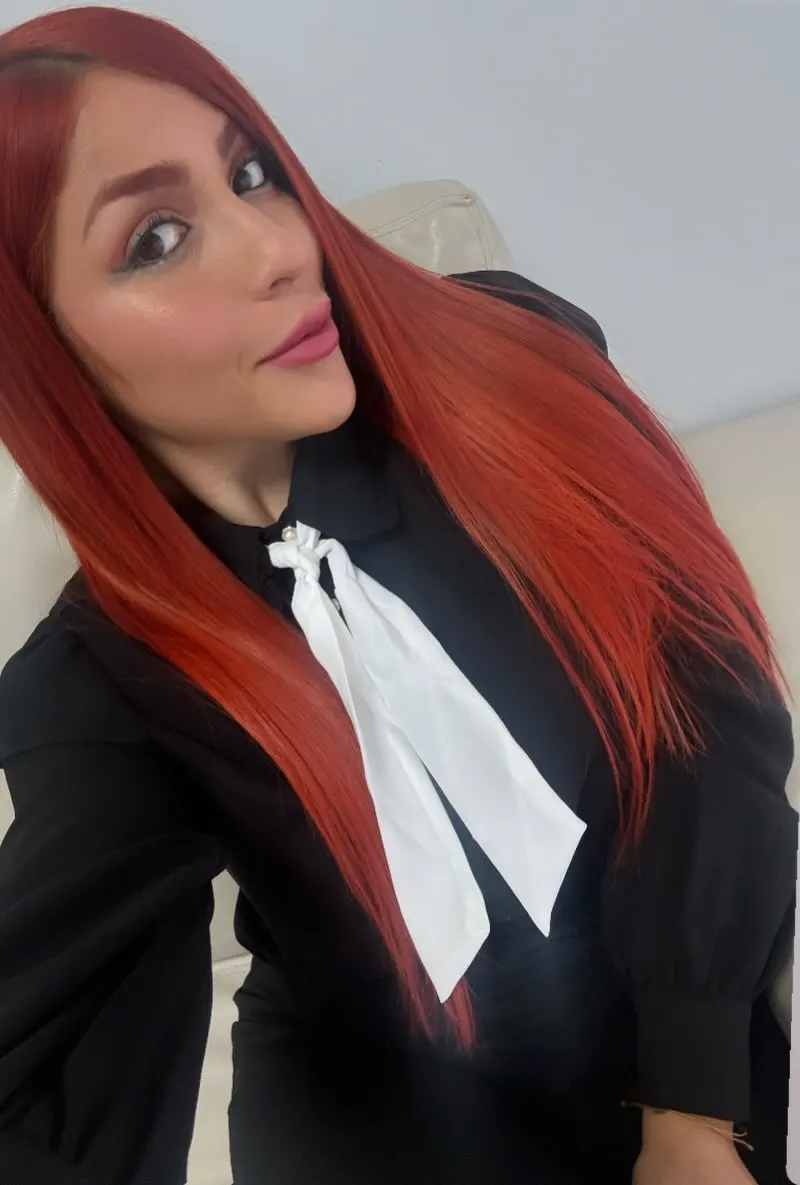 Anna Lorena Padilla con blusa negra y lazo blanco